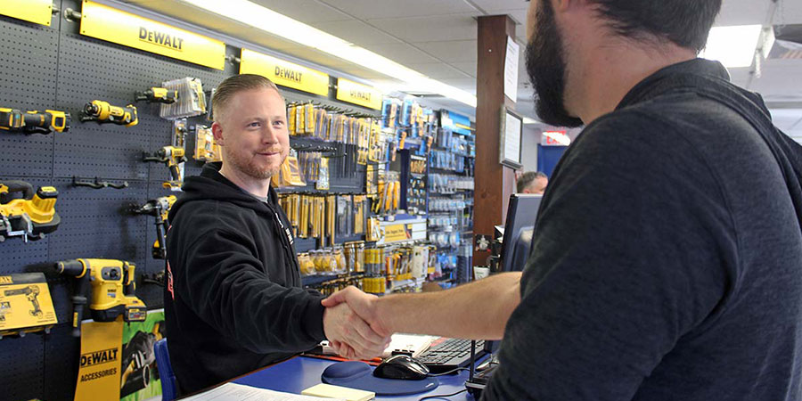 Employee shaking customers hand